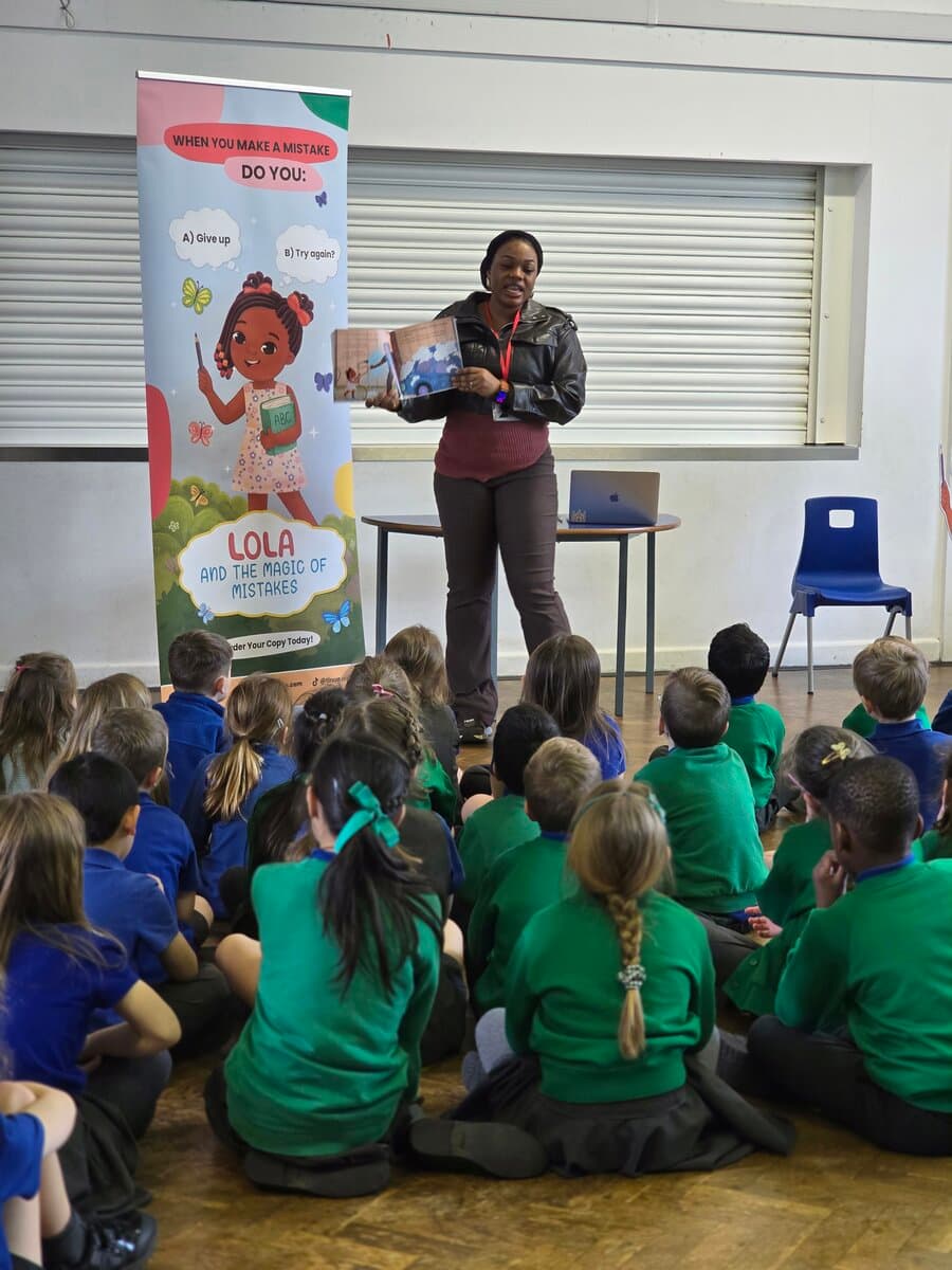 Tinu with Lola banner at school visit
